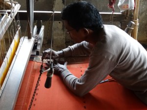 a weaver creating a brocade edge